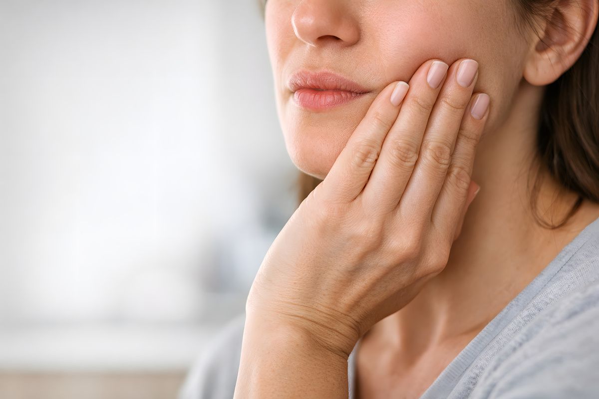 Woman Holding Jaw in Discomfort – Dental Emergency – Tooth Pain Woman Holding Jaw in Discomfort - Dental Emergency - Tooth Pain