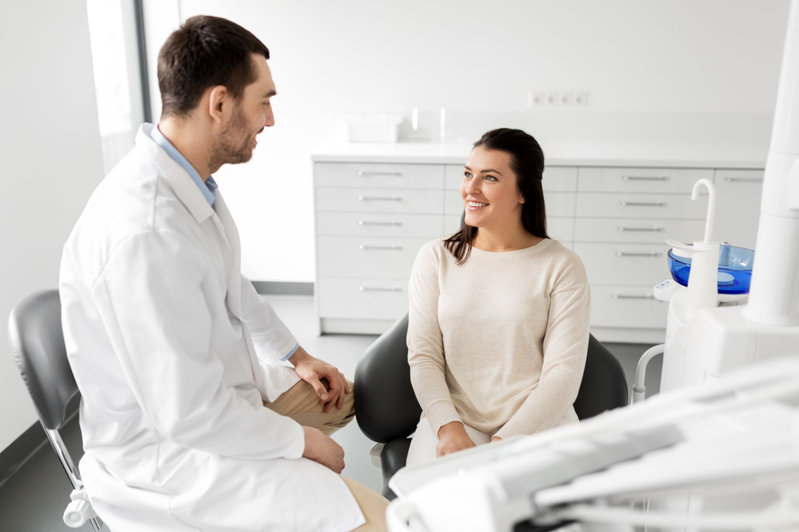 AdobeStock_210654708 Patient smiling during a comfortable holistic dental consultation