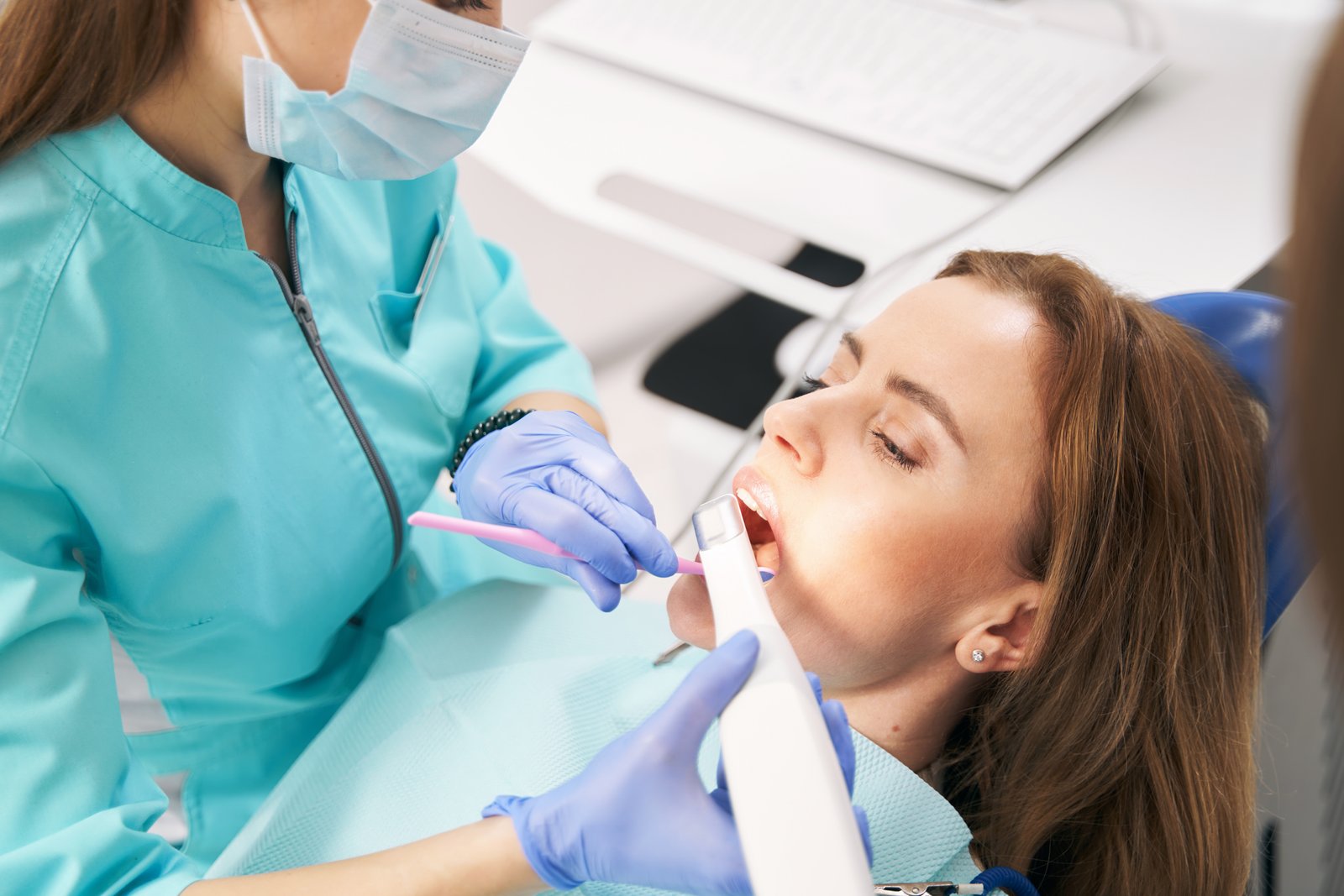image-1786542492489 Dentist using a digital intraoral scanner to capture a patient's teeth for a crown, aligner, or implant restoration