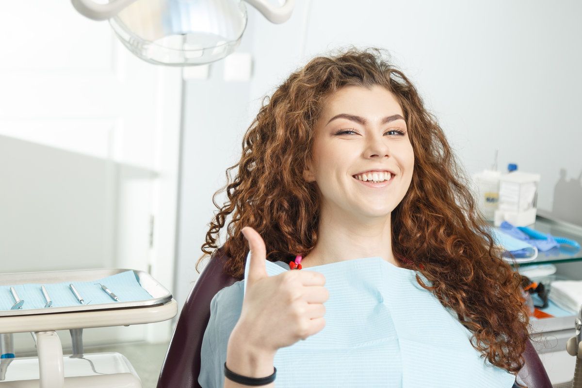 Smiling woman giving thumbs up