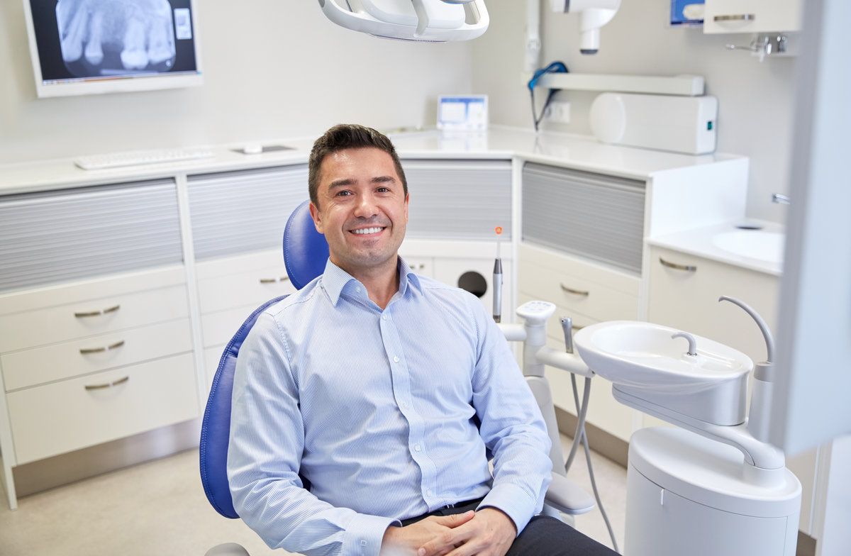 Smiling man in a dental office.